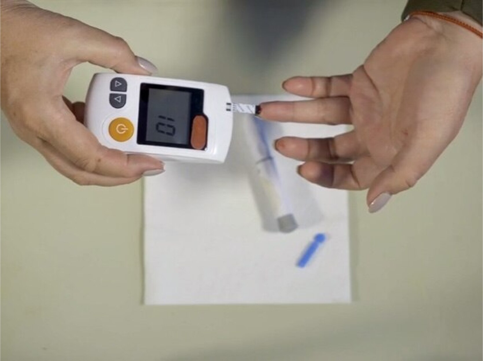 A MinuteClinic patient using a glucometer to read their blood glucose level.