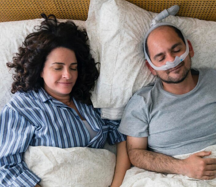 A continuous positive airway pressure (CPAP) machine helps a man with obstructive sleep apnea get uninterrupted sleep.