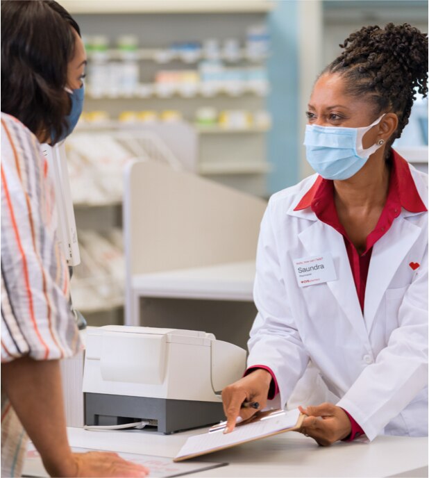 CVS pharmacist smiles while assisting a customer
