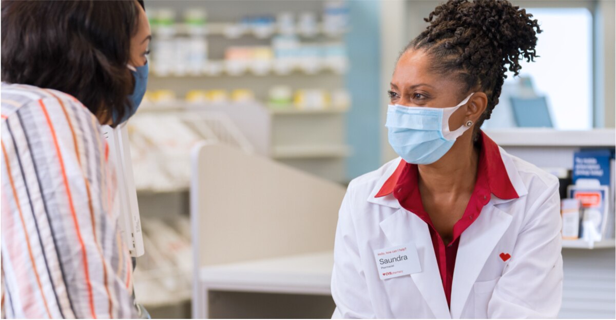 CVS pharmacist smiles while assisting a customer