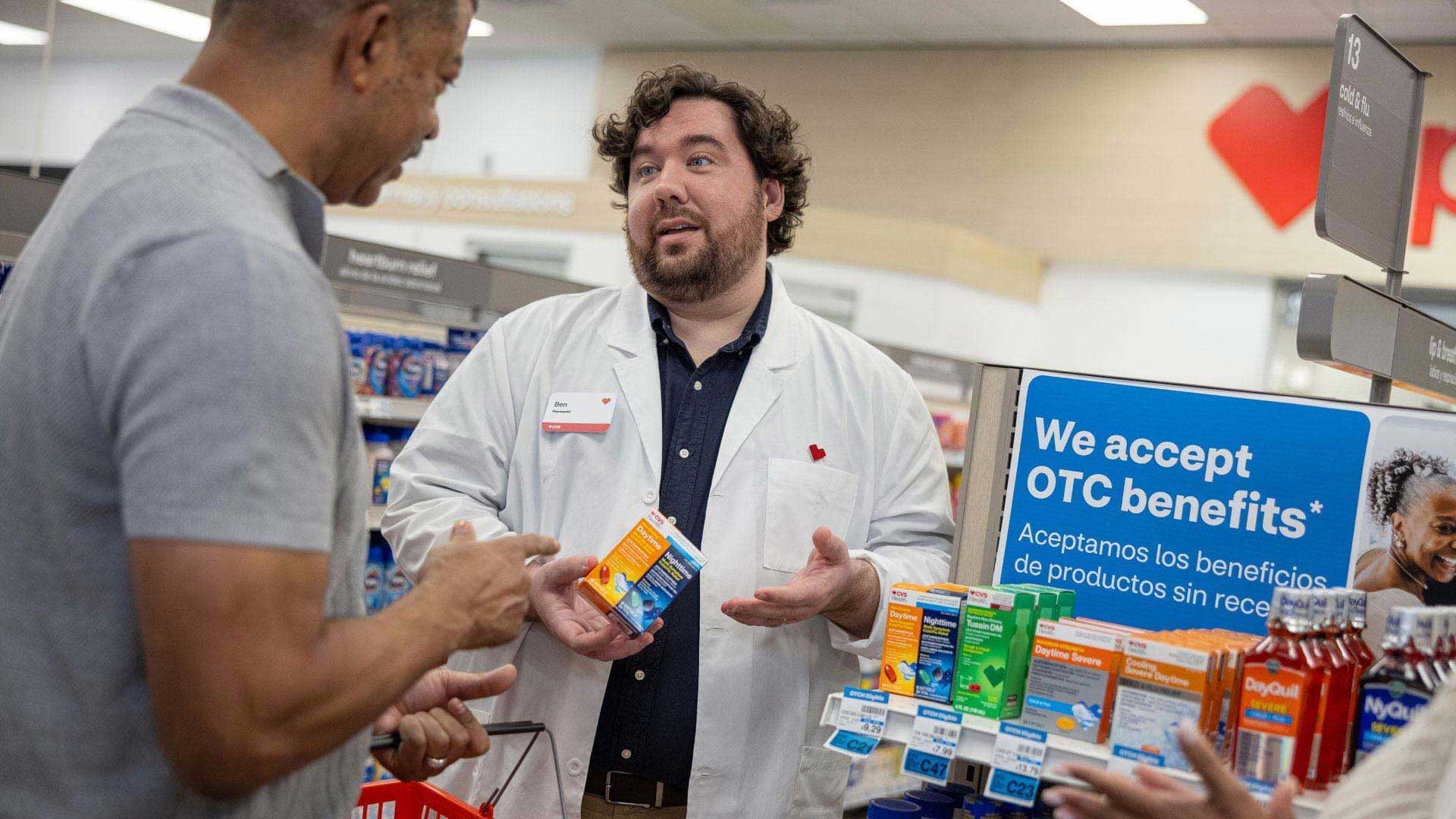 A pharmacist talks to a patient about medication options.