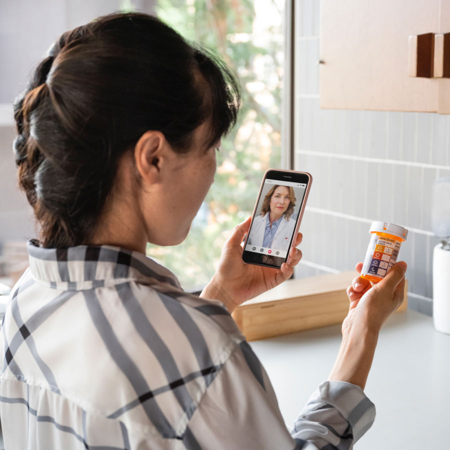 A customer on a telehealth call at home talks to their provider about their prescriptions.